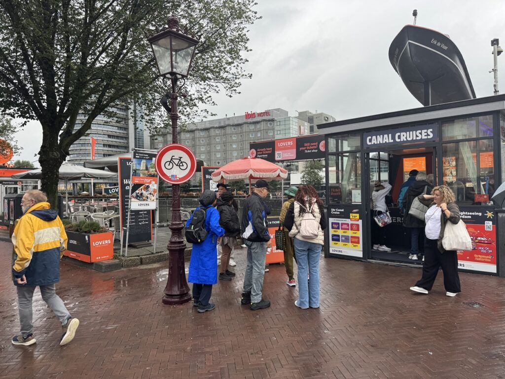 Tourists waiting in line to buy Lovers canal cruise tickets at the departure point